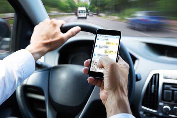 The cost of using hand-held phones while driving